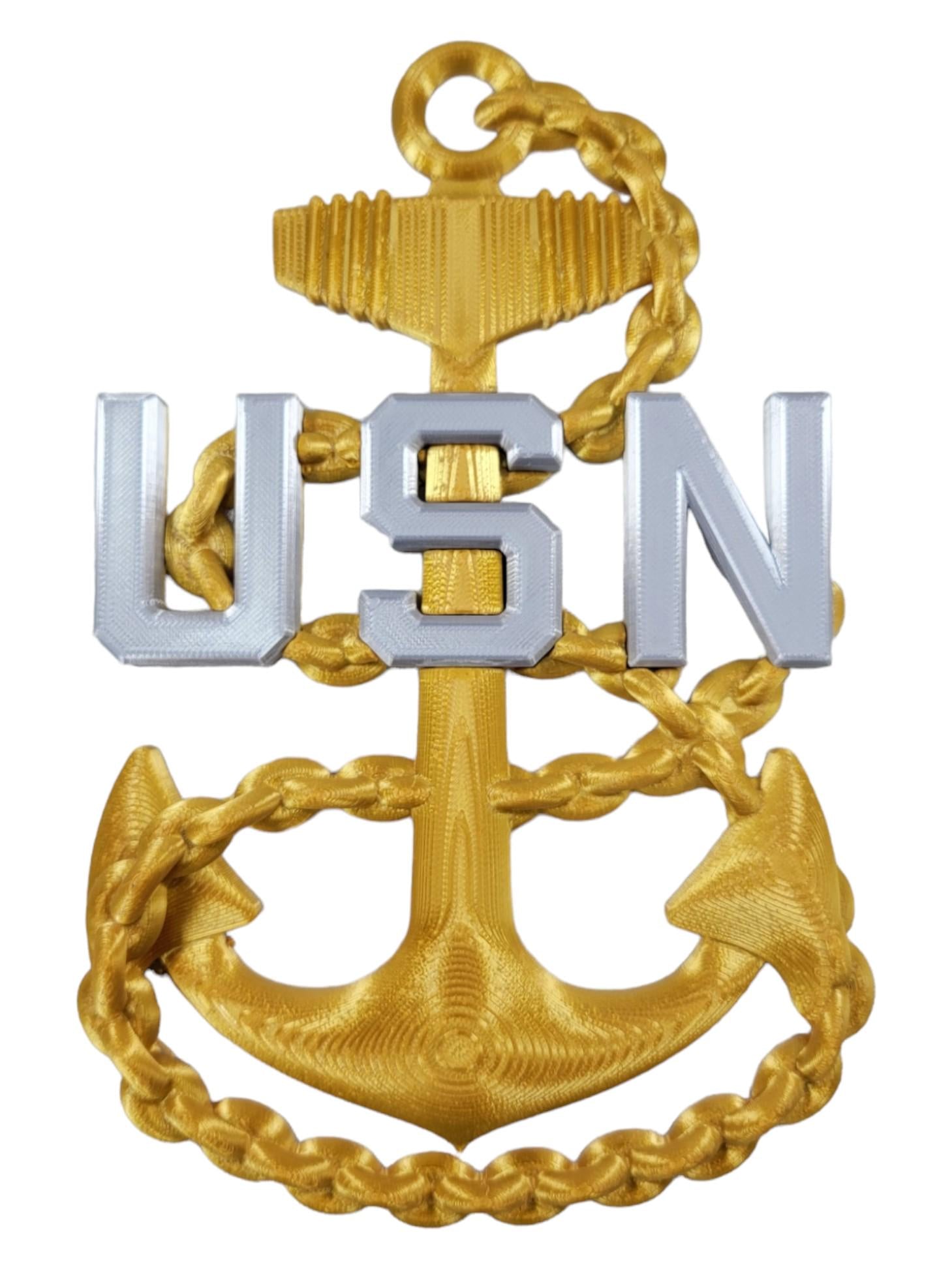 US Navy CPO E-7 rank insignia with a gold anchor and silver 'USN' letters on a white background.